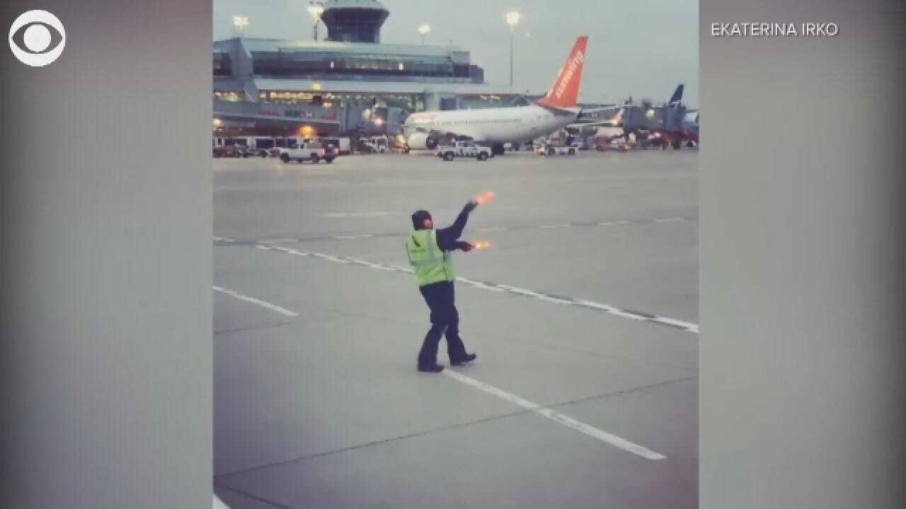 Airline Worker Does Silly Dance To Try To Cheer Up Crying Baby