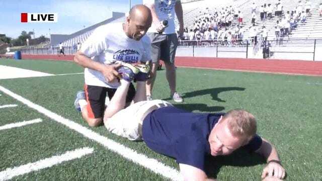 News On 6 Reporter Tony Russell Stretches With The NFL Stars