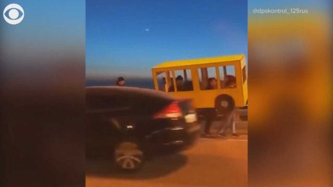 Russian Pedestrians Disguise Themselves As Bus For Vehicle Only Bridge