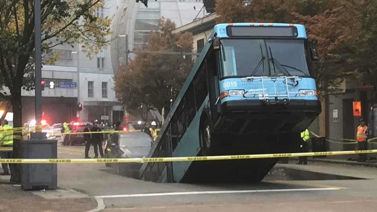 Sinkhole Opens, Swallows Part Of City Bus During Rush Hour