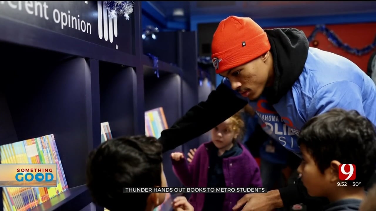 OKC Thunder Players Hand Books Out To Greenvale Elementary Students