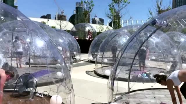WATCH: People Practice Yoga Inside Individual Domes