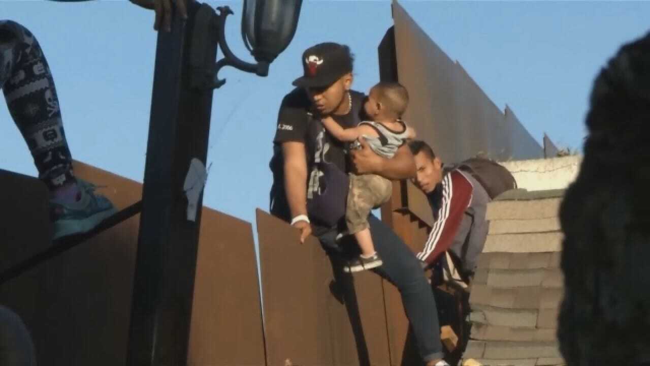 Father, Baby Detained After Climbing Border Fence