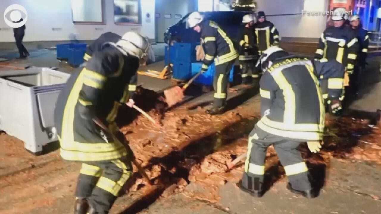 Workers Try To Stop Chocolate From Overflowing Into The Streets
