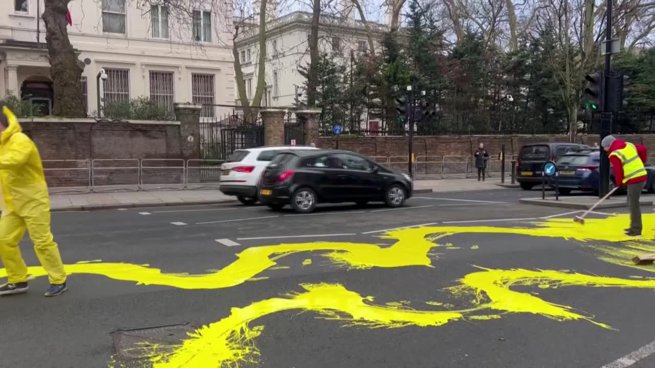 Protesters Paint Ukrainian Flag Outside Russian Embassy In London 