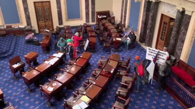 Watch: Rioters Wave Flags Inside U.S. Senate Chamber